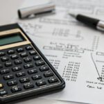 Budgeting - Black Calculator Near Ballpoint Pen on White Printed Paper
