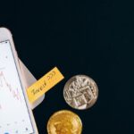 Cryptocurrencies - Silver Iphone 6 Beside Silver Round Coins